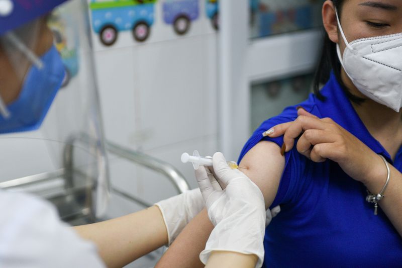 FILE PHOTO: FILE PHOTO: A woman receives a vaccine as