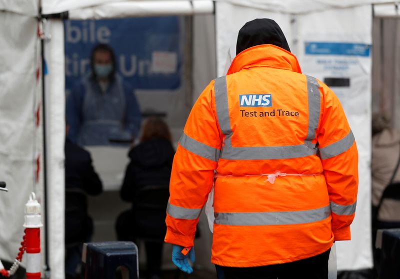 An NHS worker stands near a coronavirus disease (COVID-19) mobile