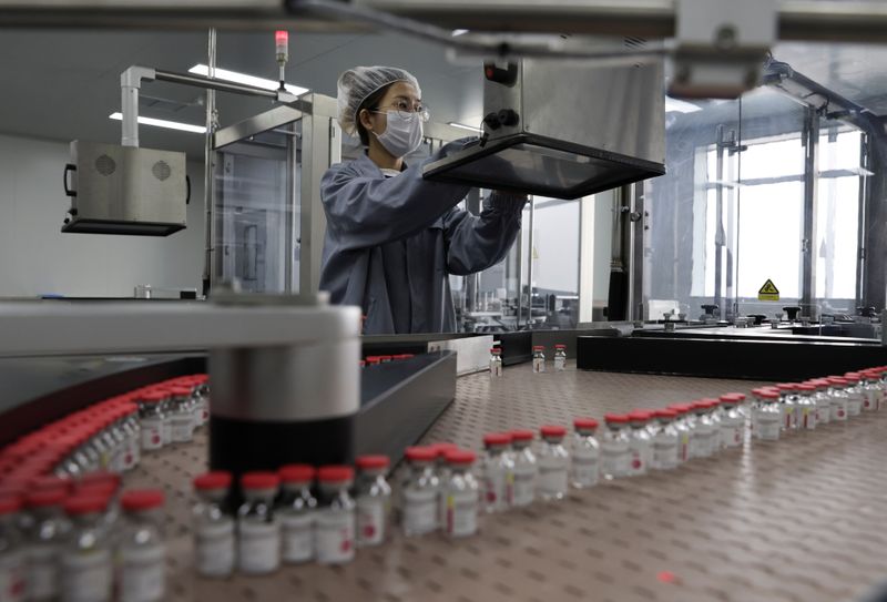 Employee works on the production line of CanSino’s single-dose COVID-19
