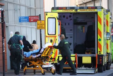 Paramedics transfer a patient outside the Royal London Hospital ,