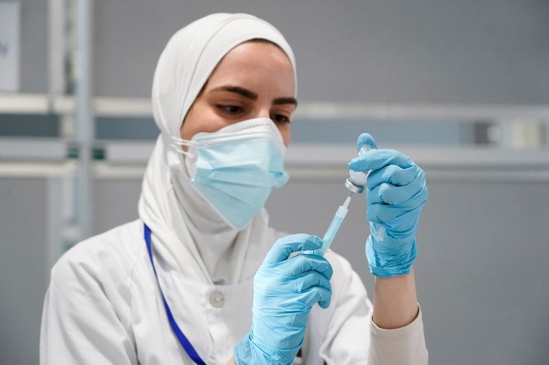 FILE PHOTO: A nurse prepares a syringe with a dose