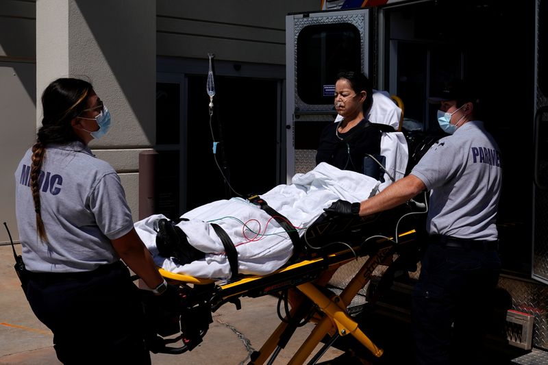 Paramedics unload a potential coronavirus disease patient at the hospital