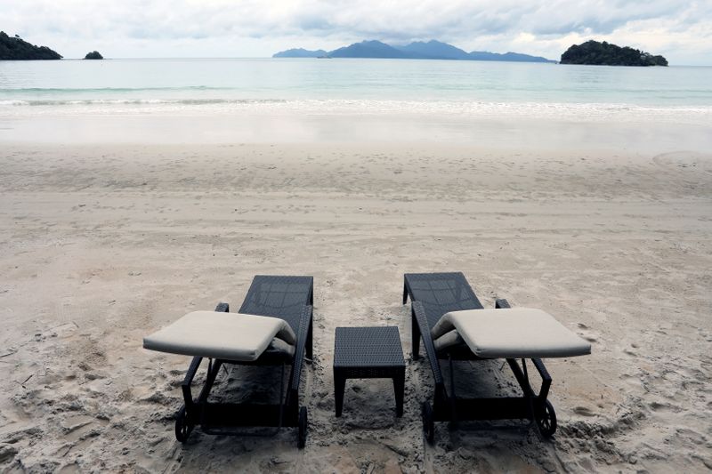 Empty chairs are seen at The Datai Langkawi resort beach