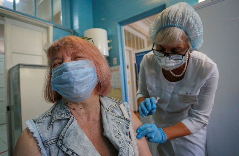 A woman is injected with Sputnik Light vaccine against the