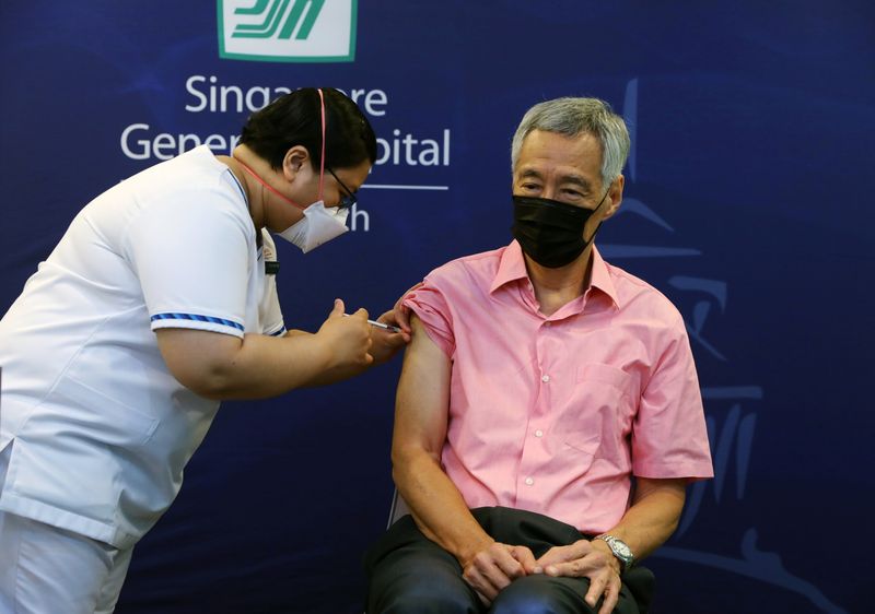 Singapore’s Prime Minister Lee Hsien Loong receives a booster shot