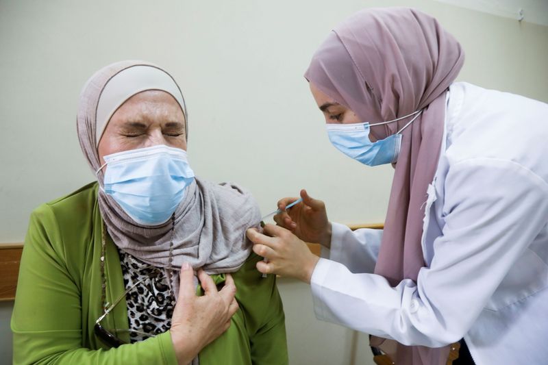 FILE PHOTO: Palestinians receive third shot of COVID-19 vaccine in