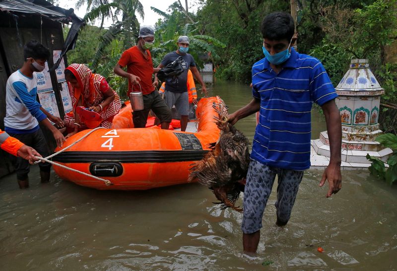 FILE PHOTO: People are evacuated from a flooded area to