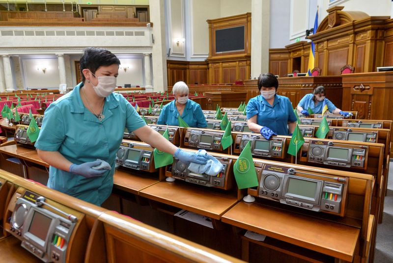 FILE PHOTO: Employees clean lawmakers’ working places to prevent the
