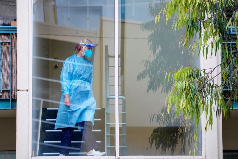 A healthcare worker walks down stairs at a complex locked