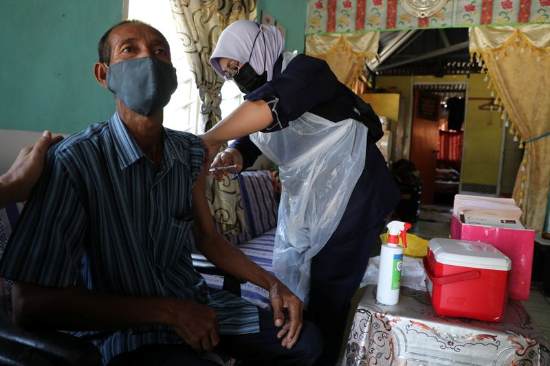 FILE PHOTO: A healthcare worker administers the Sinovac coronavirus disease