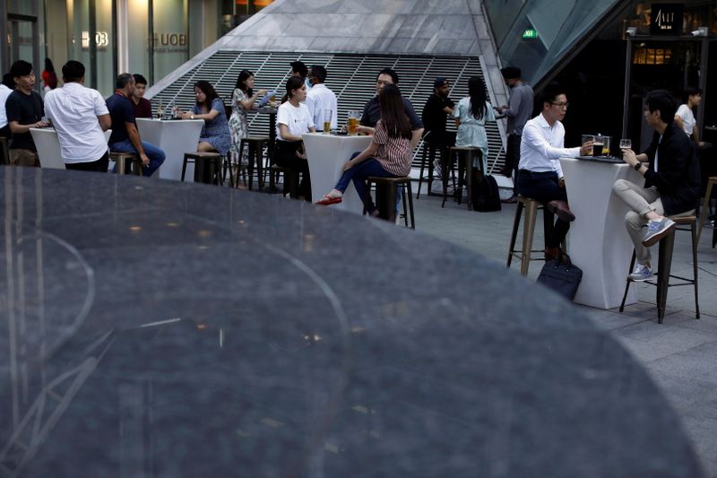 People sit at a restaurant in the central business district