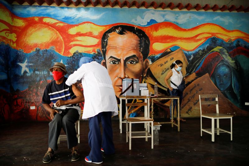 Venezuelan healthcare workers go from door to door to vaccinate