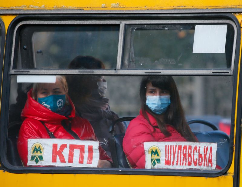 People wear protective face masks are seen in a bus