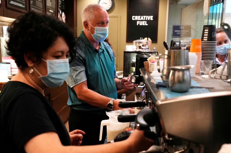 Coffee shop owner works at his franchise in Toronto’s PATH