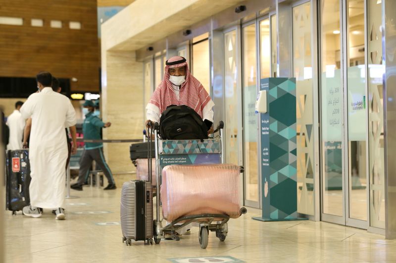 A Saudi man wearing a face mask is seen with