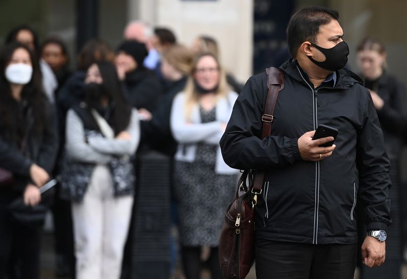 Man wearing protective face mask walks in London
