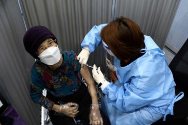 FILE PHOTO: A South Korean woman receives her first dose