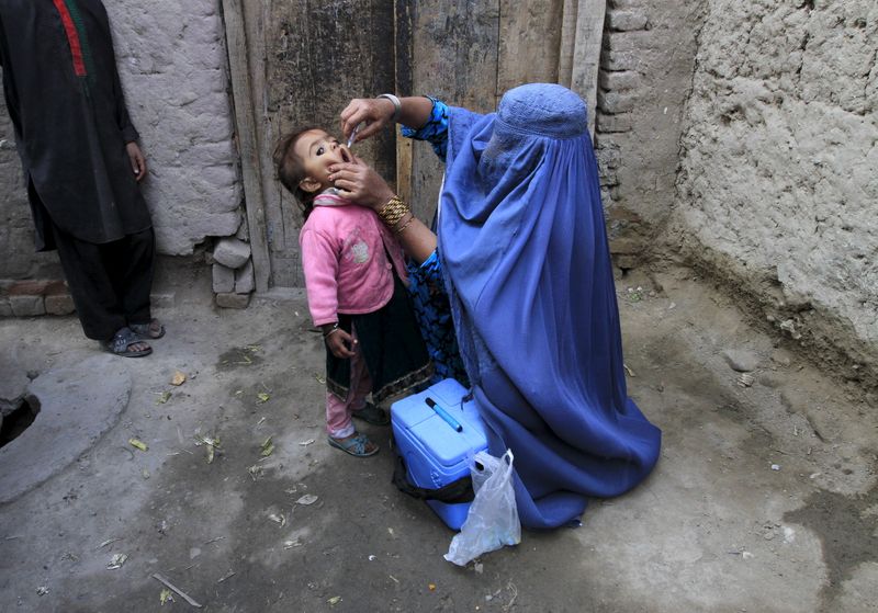 A child receives a polio vaccination during an anti-polio campaign