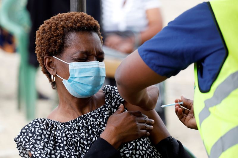 Woman receives an AstraZeneca/Oxford COVID-19 vaccine, in Nairobi