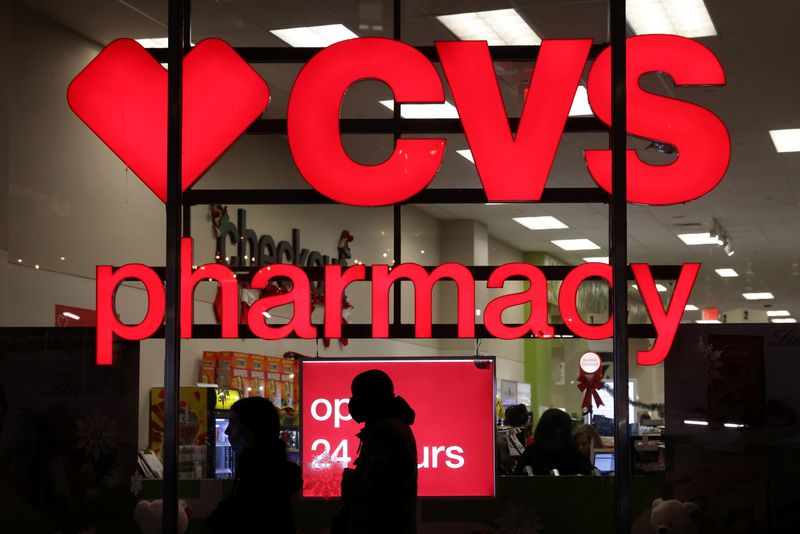 People walk by a CVS pharmacy store in Manhattan, New