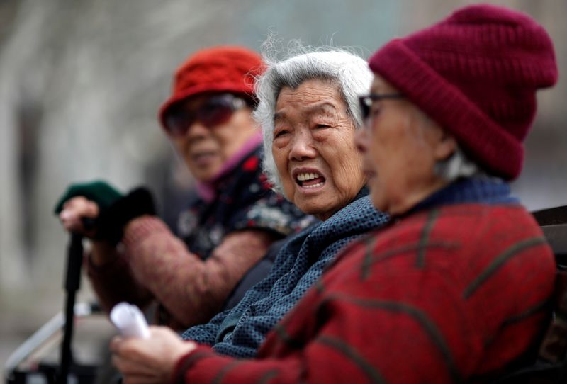 FILE PHOTO: Elderly women sit at a park in downtown