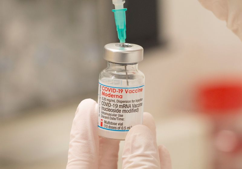 FILE PHOTO: A health care worker fills up a syringe