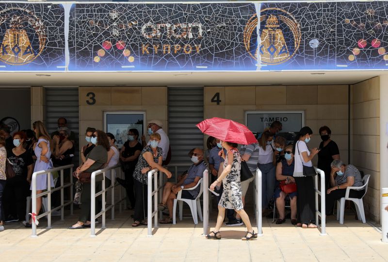 People wait outside a vaccination centre, amid the coronavirus disease