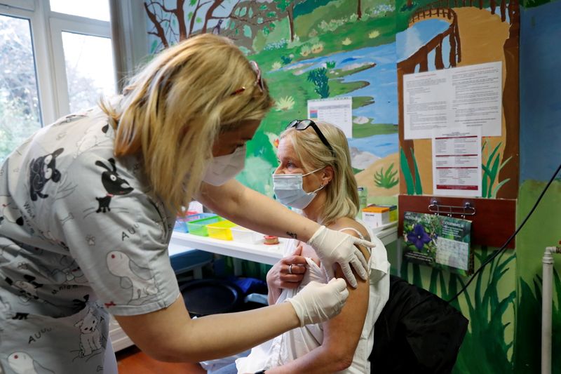 FILE PHOTO: A nurse gives a dose of the Pfizer-BioNTech