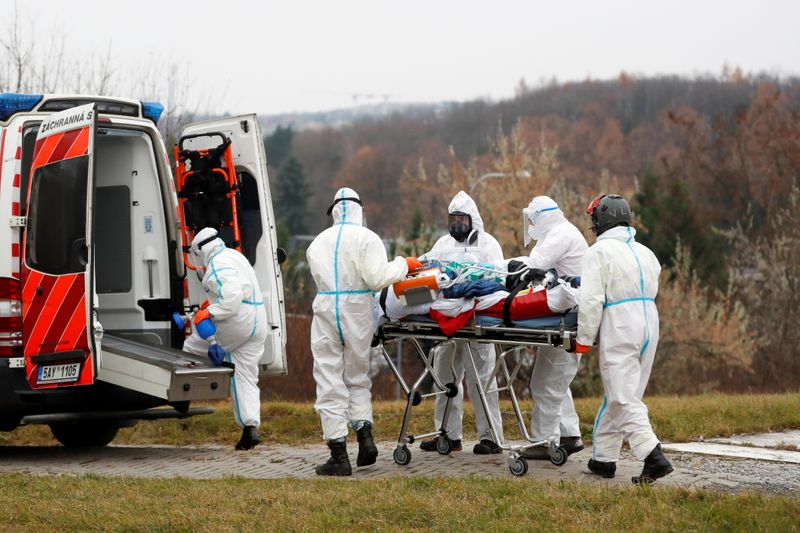 FILE PHOTO: Medical workers transport COVID-19 patients from Brno to
