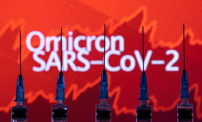 Syringes with needles are seen in front of a displayed