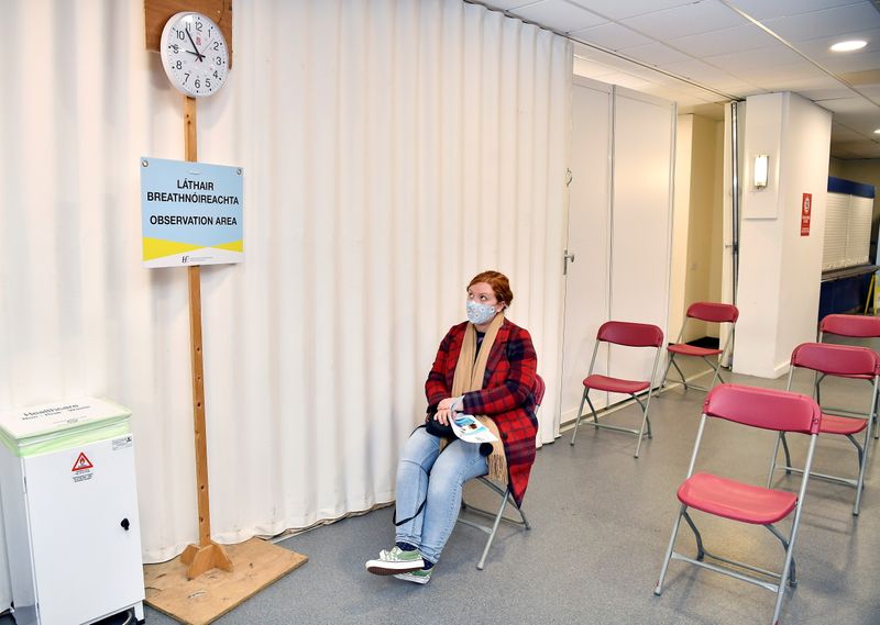 FILE PHOTO: A woman waits in an obervation area for