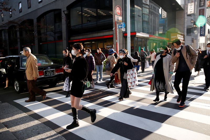 People cross the street in the Ginza shopping area, on