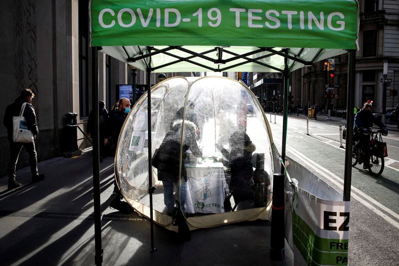 People take coronavirus disease (COVID-19) tests at a pop-up sidewalk