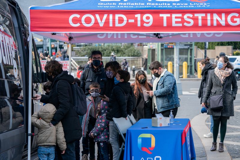 People queue at a popup COVID-19 testing site in New
