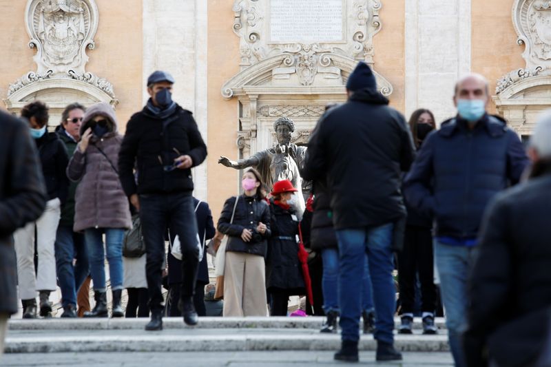 People wearing face masks walk on Capitoline Hill in Rome