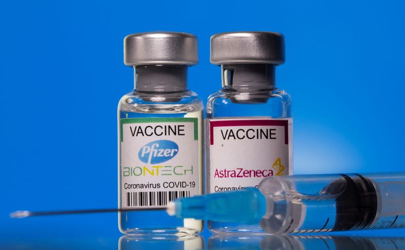 FILE PHOTO: Picture illustration of vials with Pfizer-BioNTech and AstraZeneca