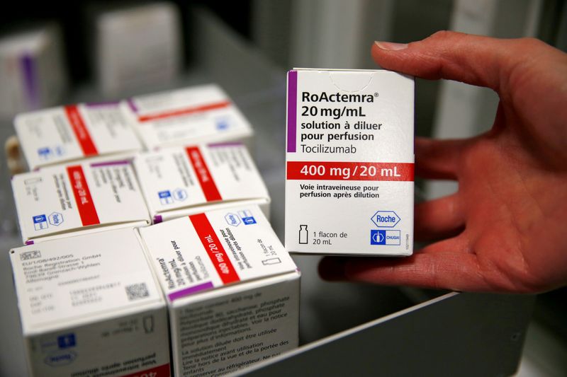 FILE PHOTO: A pharmacist displays a box of tocilizumab at