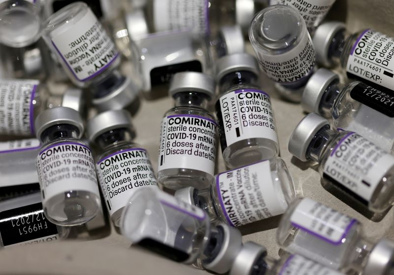 FILE PHOTO: Empty vials of the “Comirnaty” Pfizer-BioNTech COVID-19 vaccine