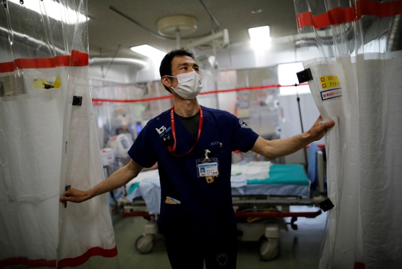 FILE PHOTO: Doctor draws curtain in critical care ward at