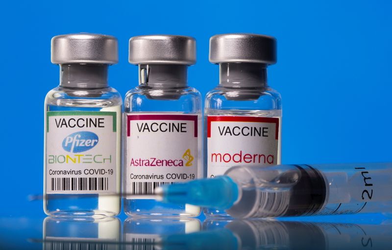 Picture illustration of vials with Pfizer-BioNTech, AstraZeneca, and Moderna coronavirus