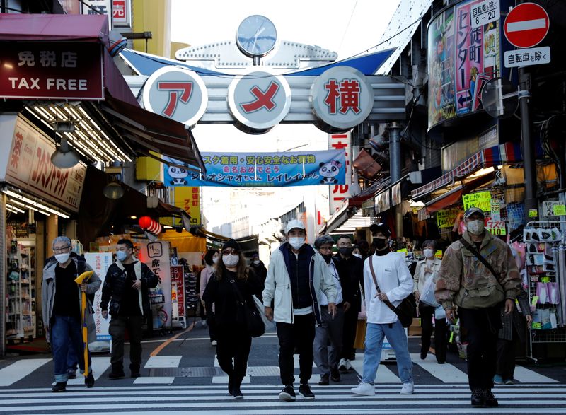 Pedestrians wearing protective masks, amid the coronavirus disease (COVID-19) outbreak,