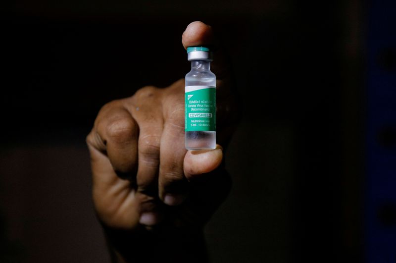 FILE PHOTO: A man displays a vial AstraZeneca’s COVISHIELD vaccine