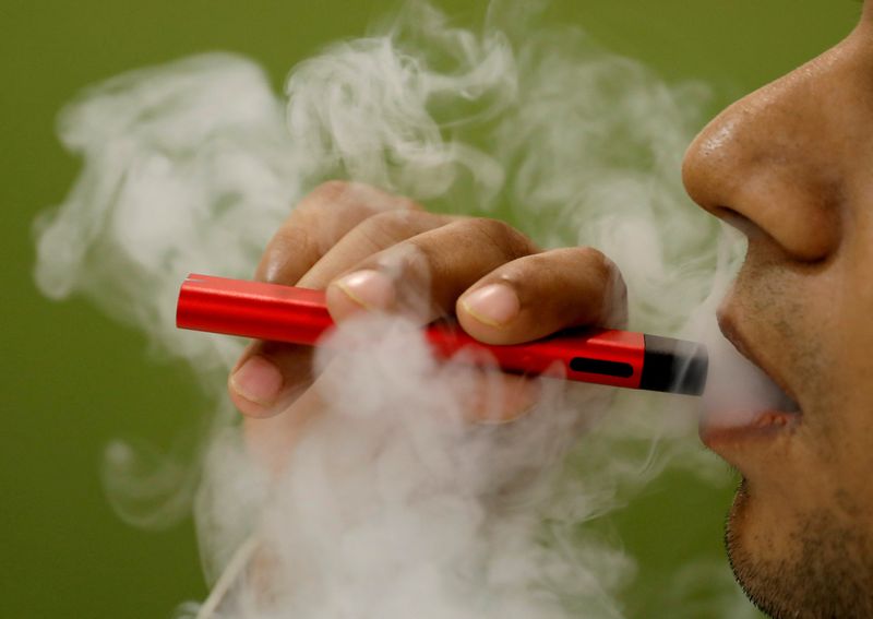 FILE PHOTO: A man uses a vape device in this