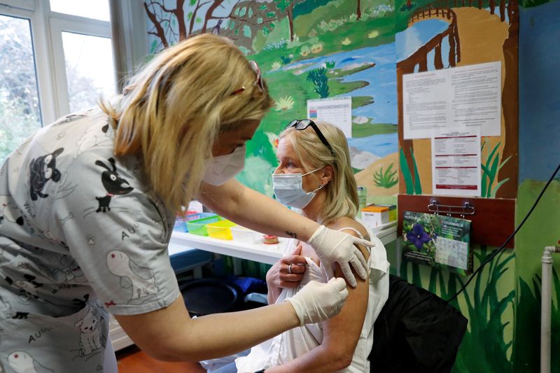 FILE PHOTO: A nurse gives a dose of the Pfizer-BioNTech