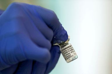 FILE PHOTO: A medical worker holds a vial of the