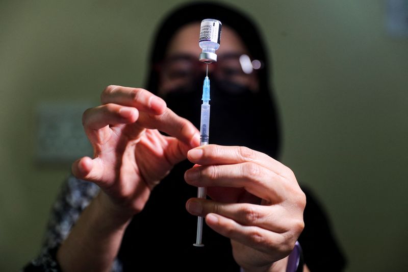 FILE PHOTO: Pharmacist prepares a dose of the coronavirus disease