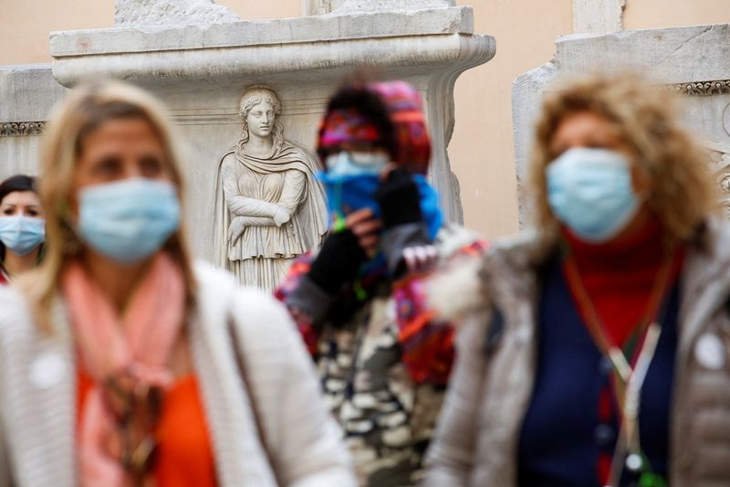 People wearing face masks walk at Capitoline Museums in Rome
