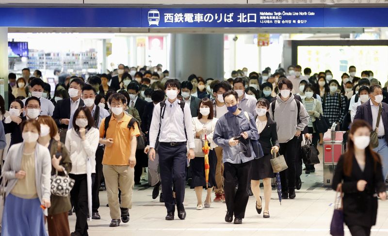 Commuters wearing protective face masks are seen a day after