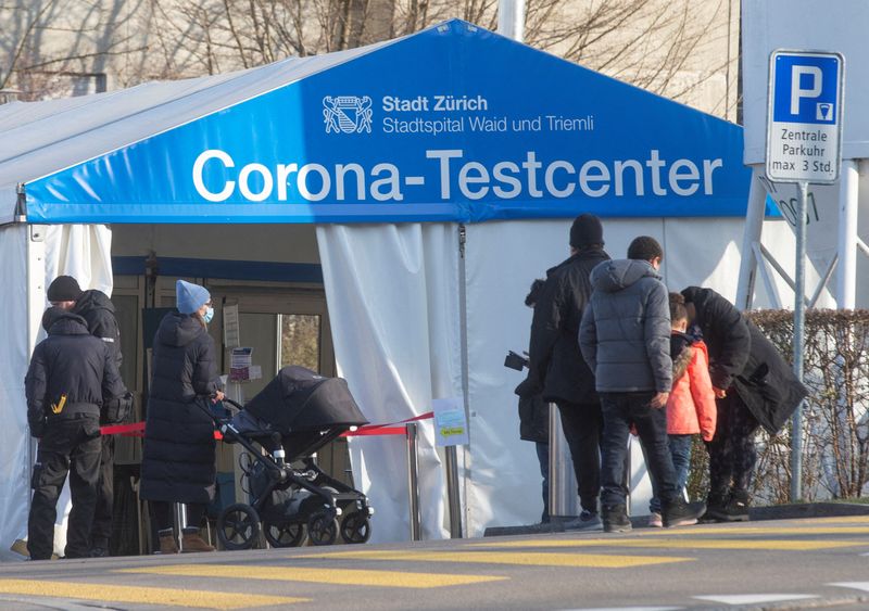 People walk past tent used for COVID-19 tests at Stadtspital