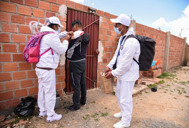 Bolivian healthcare workers go from house to house to vaccinate